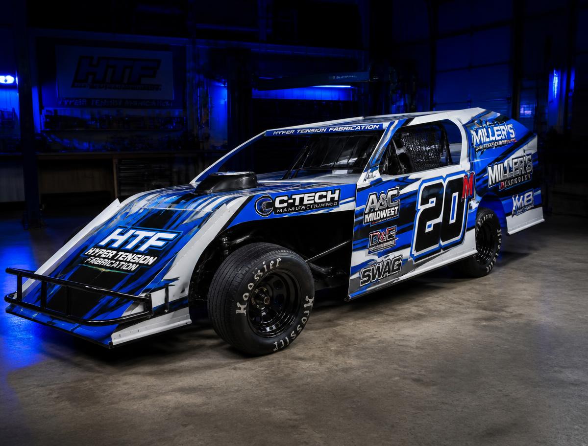Race car with a bright printed vinyl wrap in a dark shop